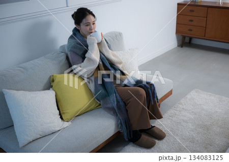 夜の灯りの部屋でホットドリンクを飲む若い女性 女性の冬イメージ 俯瞰 夜の灯りの部屋でホットドリンクを飲む若い女性 女性の冬イメージ 俯瞰 134083125