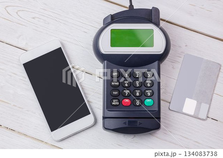 Flat design payment setup is showing smartphone, card terminal and credit card on wooden tabletop Flat design payment setup is showing smartphone, card terminal and credit card on wooden tabletop 134083738