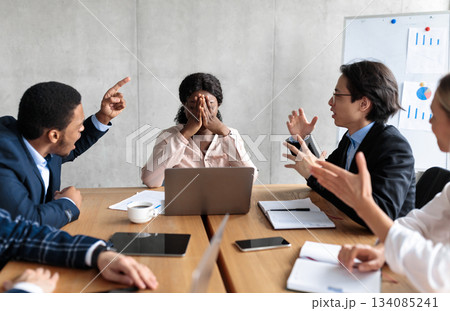 Discontented Coworkers Shouting At Unhappy Victimized Businesswoman Sitting At Table In Modern Office. Adult Bullying At Work, Conflicts And Disagreement, Business Communication Problems Concept Discontented Coworkers Shouting At Unhappy Victimized Businesswoman Sitting At Table In Modern Office. Adult Bullying At Work, Conflicts And Disagreement, Business Communication Problems Concept 134085241