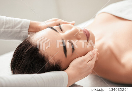 Young asian woman relaxing during face massage session at beauty spa salon, calm attractive female enjoying wellness treatments and skin care procedures at cosmetologist cabinet, closeup shot 134085294