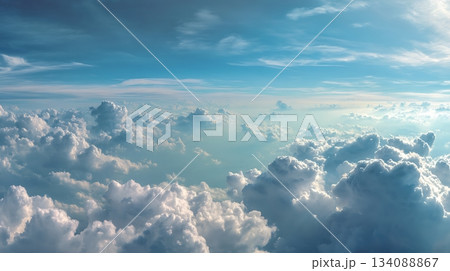 Aerial View of Fluffy Clouds and Blue Sky from Airplane Window 134088867