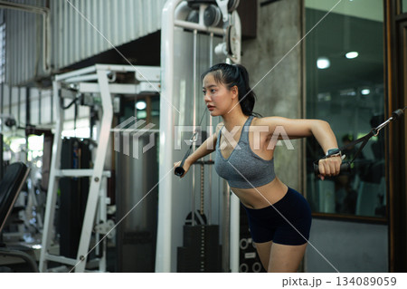 A woman exercise chest workout on cable chest press machine, Fitness and workout concept 134089059