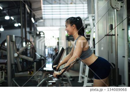 A woman exercise chest workout on cable chest press machine, Fitness and workout concept 134089068