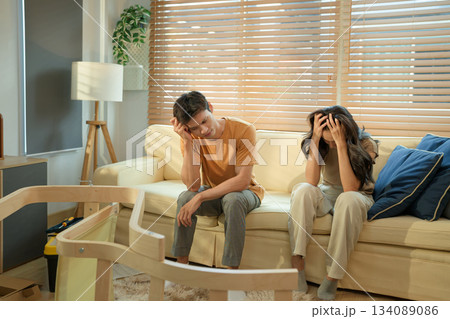 Frustrated couple having problems while assembling furniture in living room 134089086