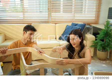 Photo series of young asian couple assembly a new furniture at home 134089090