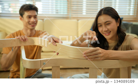 Photo series of young asian couple assembly a new furniture at home Photo series of young asian couple assembly a new furniture at home 134089109