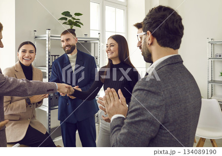 Team leader handshaking employee congratulating with professional achievement Team leader handshaking employee congratulating with professional achievement 134089190