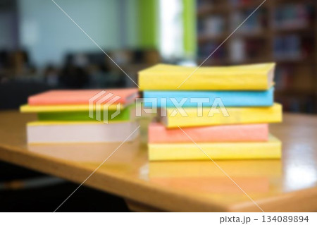 Stack of books on table at library 134089894