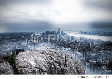 Large rock overlooking huge city 134089917