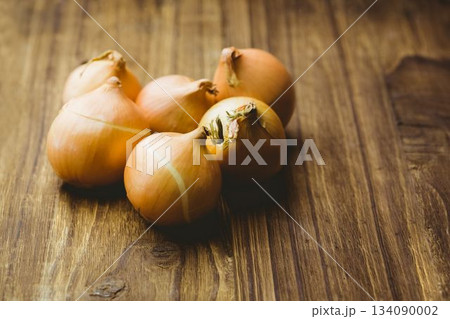 Fresh onion on wooden tables 134090002