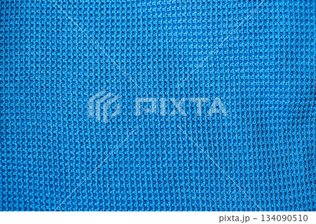Blue knitted fabric texture with waffle pattern Blue knitted fabric texture with waffle pattern 134090510