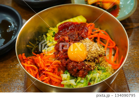 Traditional Korean brass bowl with raw beef and egg yolk from Jeonju Bibimbap 134090795