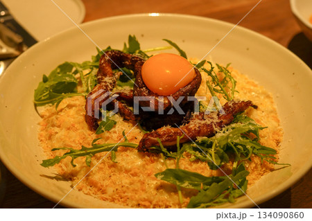 Creamy Risotto Topped with Grilled Chicken and Egg Yolk 134090860