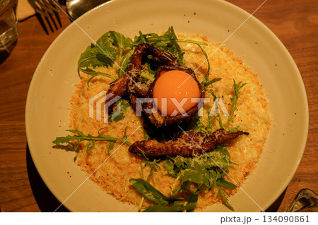 Creamy Risotto Topped with Grilled Chicken and Egg Yolk Creamy Risotto Topped with Grilled Chicken and Egg Yolk 134090861