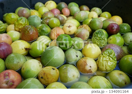 Fresh green and red passion fruit in the water for sale at the market 134091164