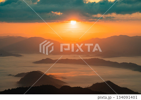 Breathtaking Sunrise Over Misty Mountains and Valleys, Showcasing a Tranquil Landscape of Nature's Beauty at Dawn with Vibrant Colors and Soft Clouds Breathtaking Sunrise Over Misty Mountains and Valleys, Showcasing a Tranquil Landscape of Nature's Beauty at Dawn with Vibrant Colors and Soft Clouds 134091401
