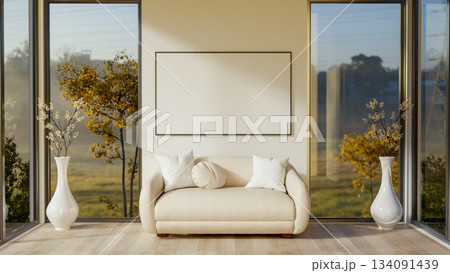 Blank frame over a white sofa between two glass doors of a wooden floor room with scenery outside. 134091439