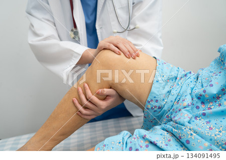 Doctor checking Asian elderly woman patient knee replacement surgery in hospital. Doctor checking Asian elderly woman patient knee replacement surgery in hospital. 134091495