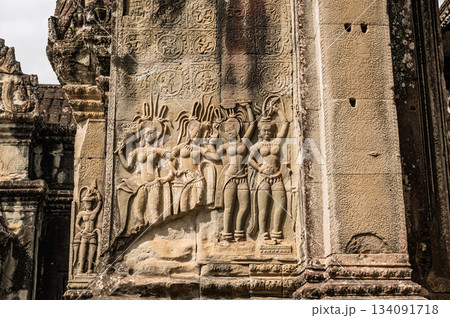 Detailed stone bas-relief depicting group of four Apsara celestial dancers on exterior wall of ancient Khmer temple in Siem Reap Detailed stone bas-relief depicting group of four Apsara celestial dancers on exterior wall of ancient Khmer temple in Siem Reap 134091718