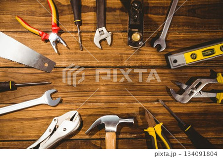hand tools are being shown in flat design on wooden workbench with hammer, pliers, copy space 134091804