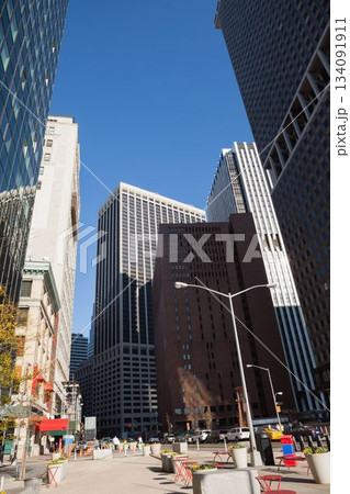Flat design illustration is depicting busy urban plaza with red metal chairs and high-rise facades 134091911