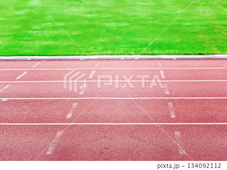 Flat design is showing red track lanes with white markings over grass field, transparent background 134092112