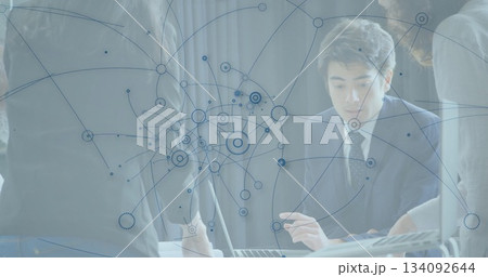 Collaborating man and female colleagues analyzing network diagram on laptop in boardroom, data flow Collaborating man and female colleagues analyzing network diagram on laptop in boardroom, data flow 134092644