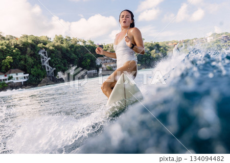 Surfer on surfboard during surfing. Surfer woman and ocean wave Surfer on surfboard during surfing. Surfer woman and ocean wave 134094482