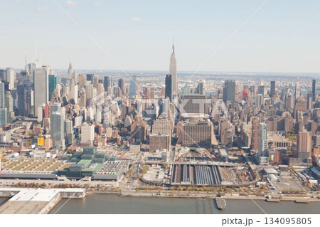 View of cityscape by river against sky on sunny day 134095805