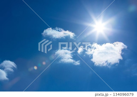 Sun is shining in flat design deep blue sky, with fluffy clouds and vibrant lens flare Sun is shining in flat design deep blue sky, with fluffy clouds and vibrant lens flare 134096079