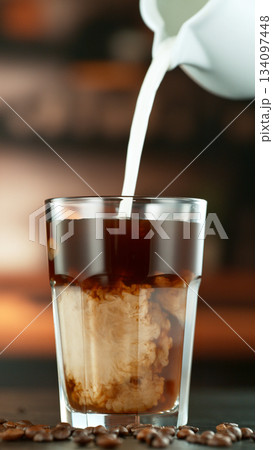 Freeze Motion Shot of Pouring Milk into Coffee in a Cafe Freeze Motion Shot of Pouring Milk into Coffee in a Cafe 134097448