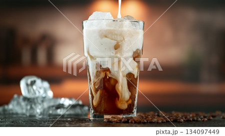 Macro Shot of Pouring Milk into Ice Coffee, Close-up 134097449