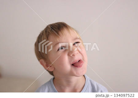Young child making playful silly face sticking out tongue Young child making playful silly face sticking out tongue 134097522