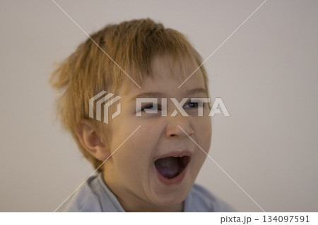 Young boy shouting with open mouth expressing emotion 134097591