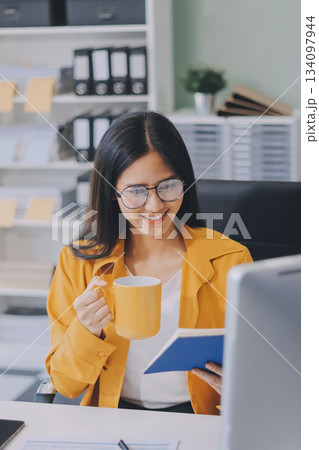 Business woman using calculator for do math finance on wooden desk in office and business working background, tax, accounting, statistics and analytic research concept. 134097944