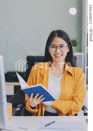Business woman using calculator for do math finance on wooden desk in office and business working background, tax, accounting, statistics and analytic research concept. 134097945