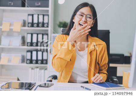 Business woman using calculator for do math finance on wooden desk in office and business working background, tax, accounting, statistics and analytic research concept. 134097946
