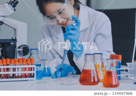 Portrait, science and happy woman on laptop in lab to research chemistry, test or innovation. Microscope, scientist and face of medical doctor in goggles for microbiology, healthcare or pharma study Portrait, science and happy woman on laptop in lab to research chemistry, test or innovation. Microscope, scientist and face of medical doctor in goggles for microbiology, healthcare or pharma study 134097966