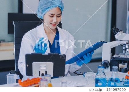 Portrait, science and happy woman on laptop in lab to research chemistry, test or innovation. Microscope, scientist and face of medical doctor in goggles for microbiology, healthcare or pharma study 134097990