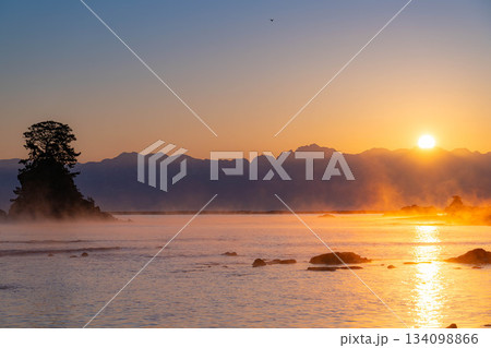 【冬の風物詩】雨晴海岸の気嵐と後立山連峰から登る朝日【富山県】 134098866
