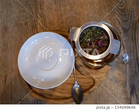 rustic tea ceremony at sunrise, serene breakfast setting featuring herbal tea and cozy rustic elements 134099646