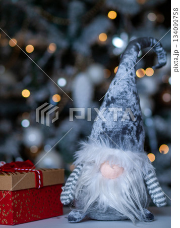 Decorative holiday scene featuring playful gnome with twinkling lights and gentle ambient background Decorative holiday scene featuring playful gnome with twinkling lights and gentle ambient background 134099758