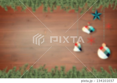 Blurred christmas decorations hanging over wood 134101037