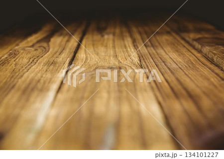 Wooden planks are showing parallel grain patterns and knots in flat design with blurred backdrop Wooden planks are showing parallel grain patterns and knots in flat design with blurred backdrop 134101227