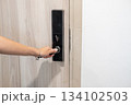 Asian woman hand opening a digital room door modern hotel technology and secure access moment 134102503