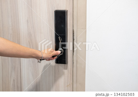 Asian woman hand opening a digital room door modern hotel technology and secure access moment Asian woman hand opening a digital room door modern hotel technology and secure access moment 134102503