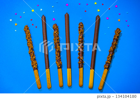 Dropped in chocolate a stick cookie Pepero. November 11th is Pepero Day in Korea Dropped in chocolate a stick cookie Pepero. November 11th is Pepero Day in Korea 134104180