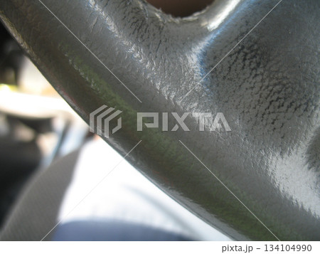 Close up steering wheel texture detail, grey vinyl surface, car interior macro, soft light, subtle wear, abstract curve Close up steering wheel texture detail, grey vinyl surface, car interior macro, soft light, subtle wear, abstract curve 134104990