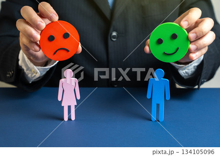 Psychologist holds a happy and angry emoji over a man and a woman. Symbol of conflicts, doubts, and therapy solutions. Suitable for family counseling, psychology, and personal relationship improvement Psychologist holds a happy and angry emoji over a man and a woman. Symbol of conflicts, doubts, and therapy solutions. Suitable for family counseling, psychology, and personal relationship improvement 134105096