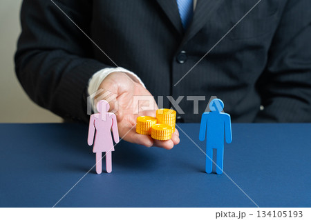 Concept of equal pay, wage equality, and gender fairness in the workplace. Financial assistance for families. Male hand holds a stack of coins between a man and a woman. 134105193